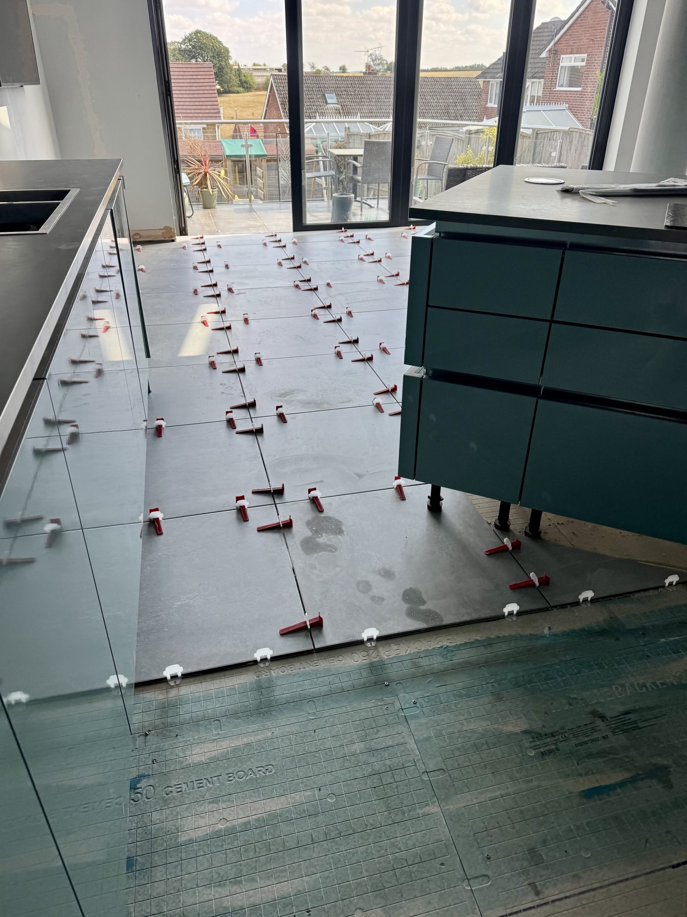 Floor tiles being fitted with levelling clips