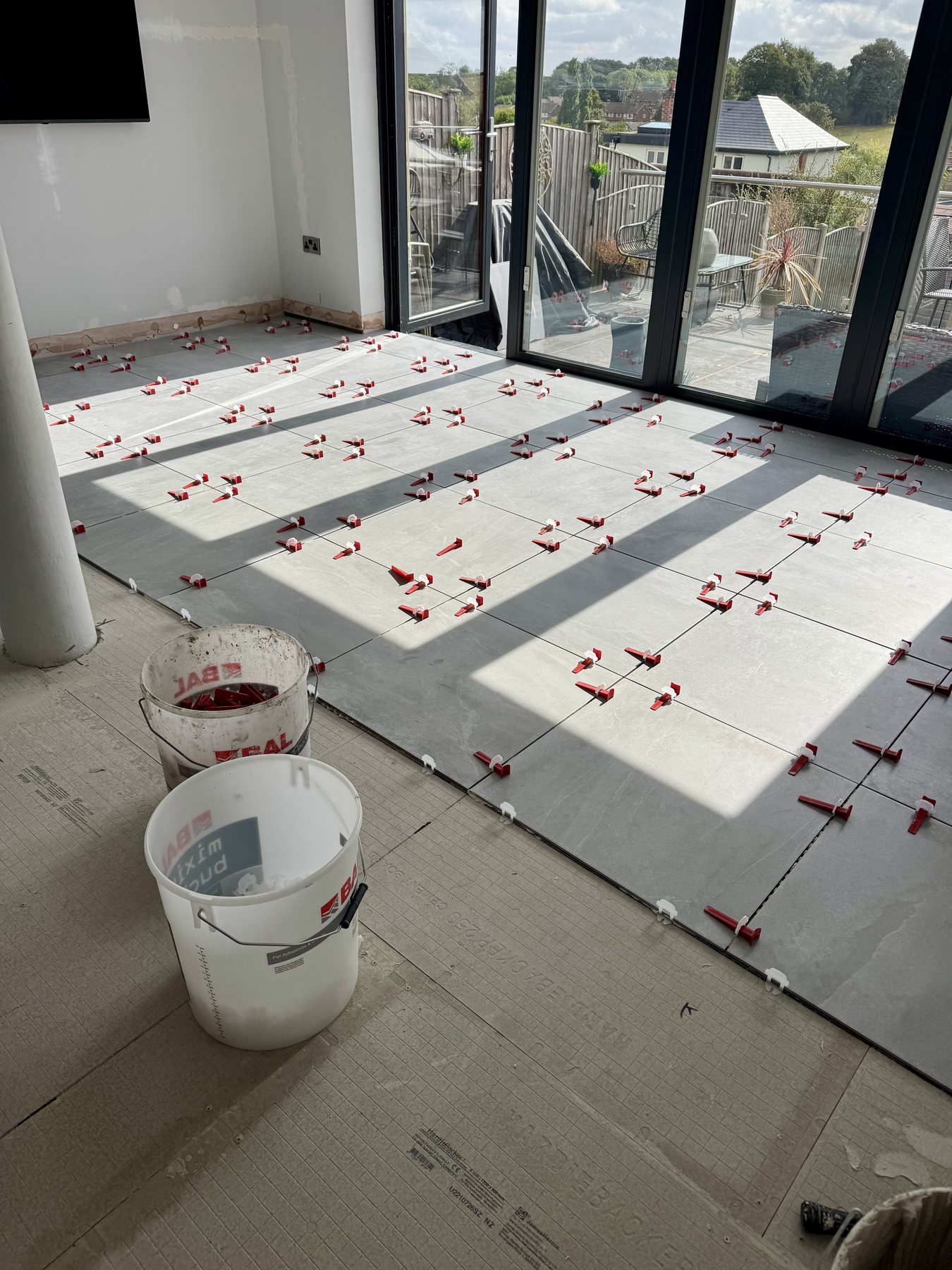 Large tiled floor installation in progress
