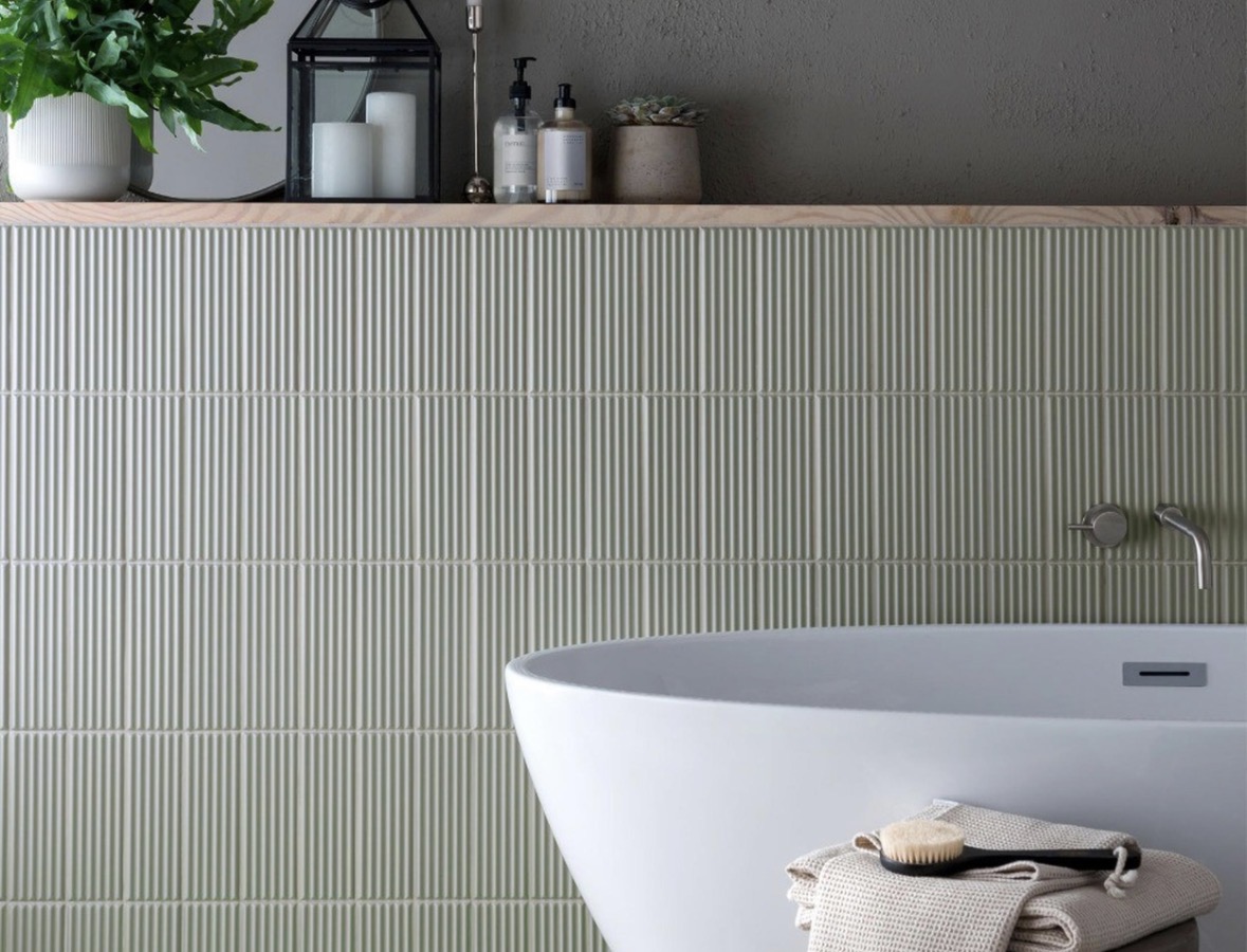 Sage green fluted tiled bath surround